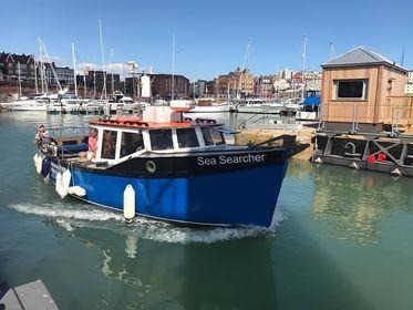 Image of a Sea Searcher boat in Ramsgate Harbour waters. It is a small boat. 
